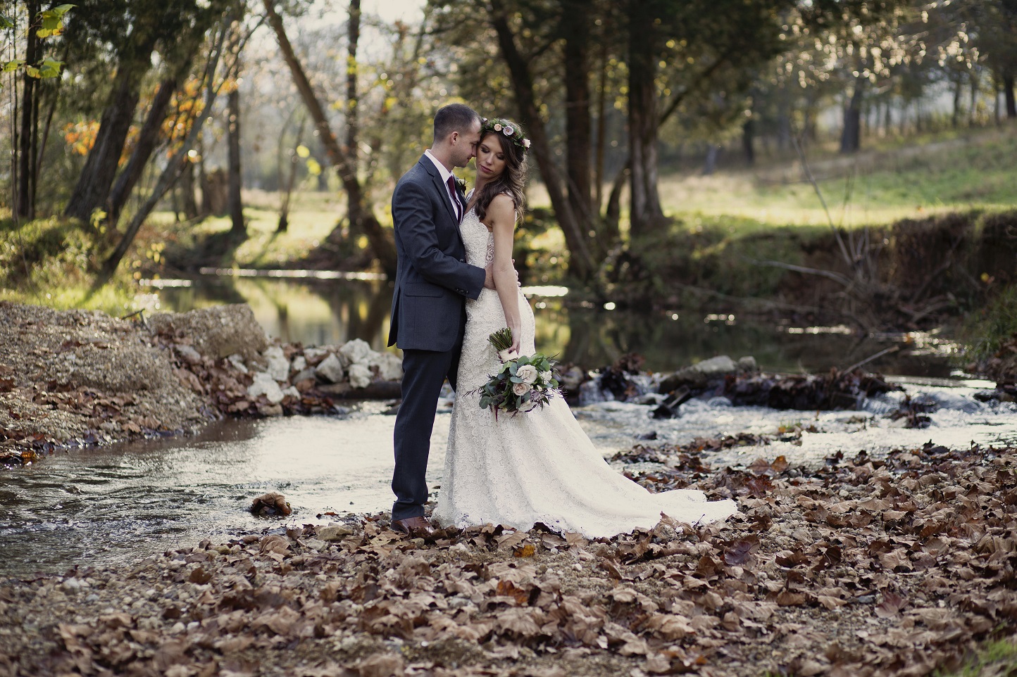 bride and groom in creek