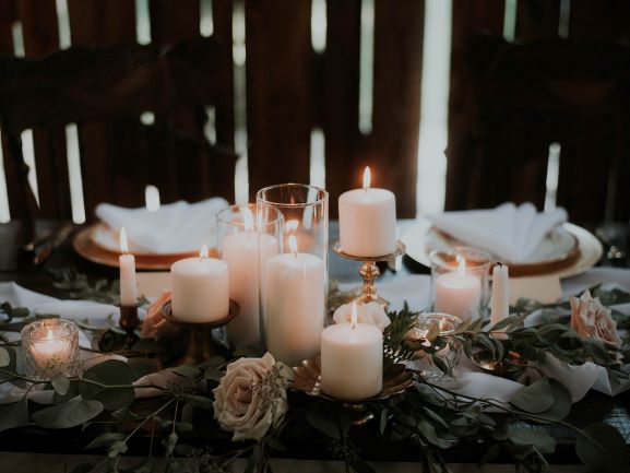 candles and greenery reception tables